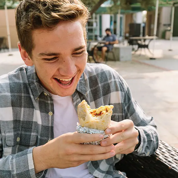 Student eating the famous breakfast burrito