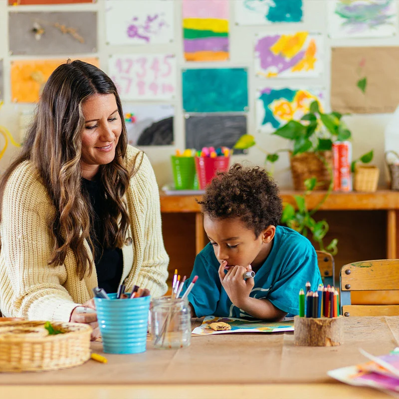 Professor speaking with a student on campus