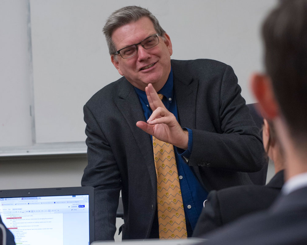 Professor speaking with students