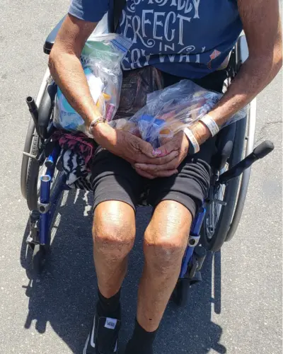 Person in wheelchair with Help Bag