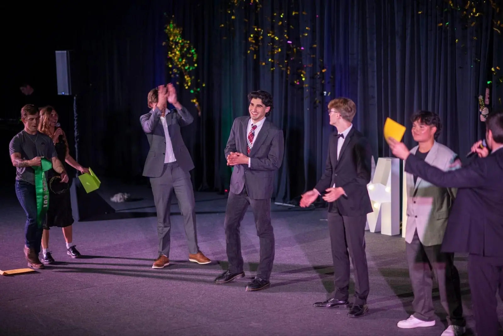 A group of people cheering and holding The Hunt flag