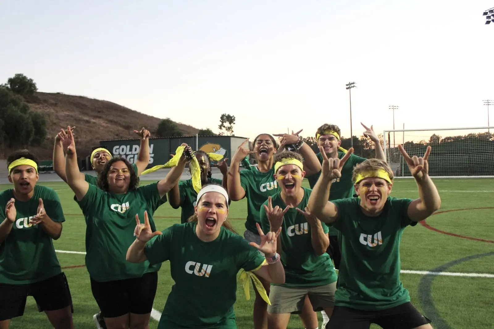 A group of people cheering and holding The Hunt flag
