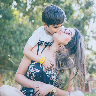 Young boy kisses mother