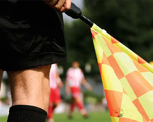 Referee holding a flag.