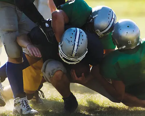 Football player being tackled