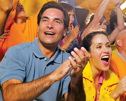 Fans clapping in the stands.