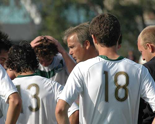 Soccer coach talking to his players