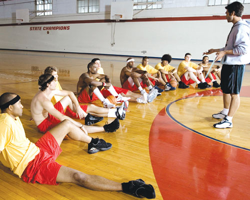 Basketball coach talking to his players