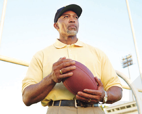 Coach holding a football.