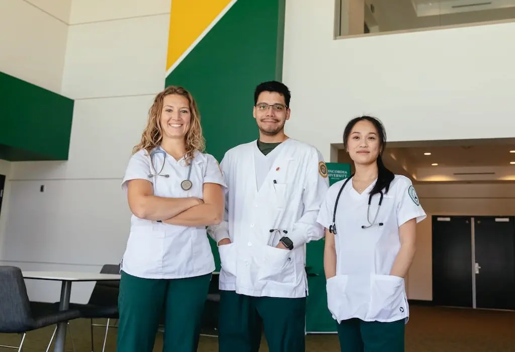 Three nurses standing and smiling