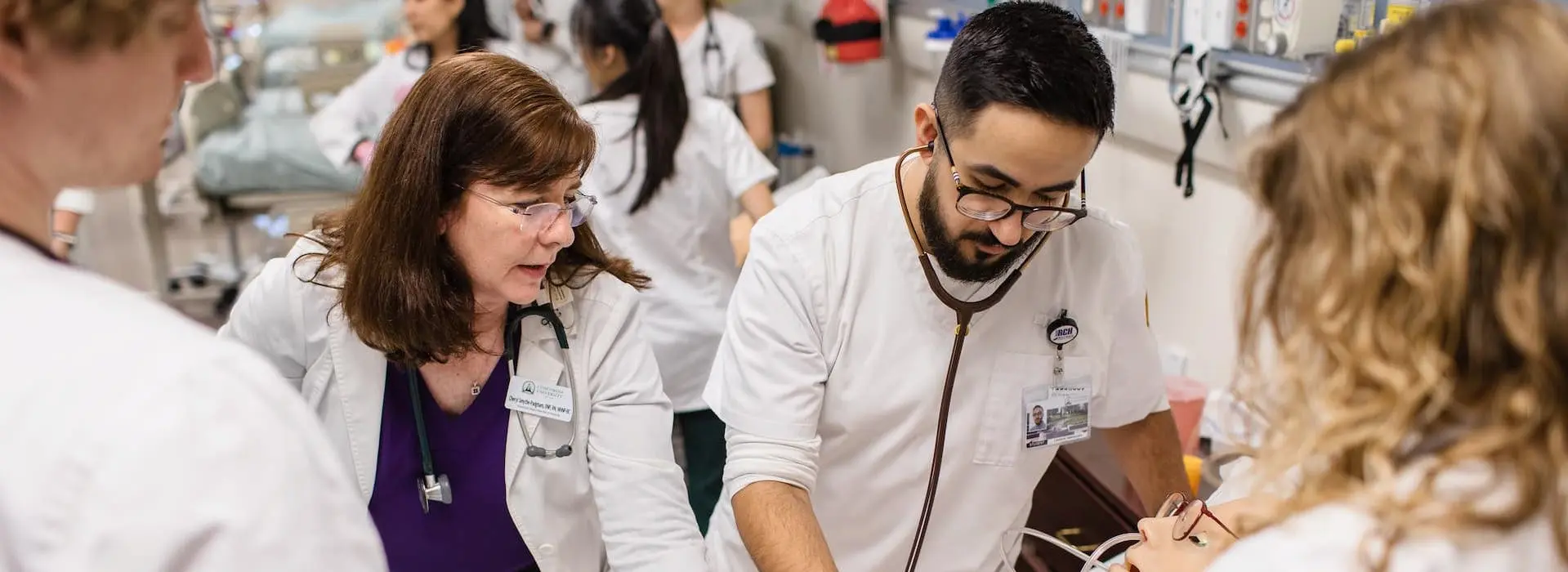 A male nurse examining a mannequin 