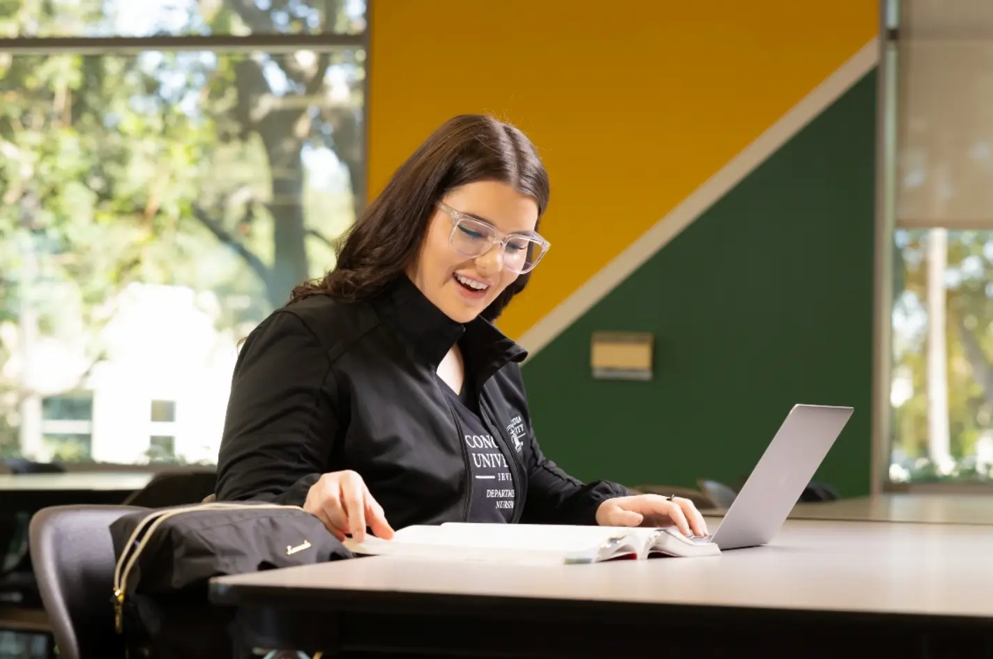 A woman studying for nursing school