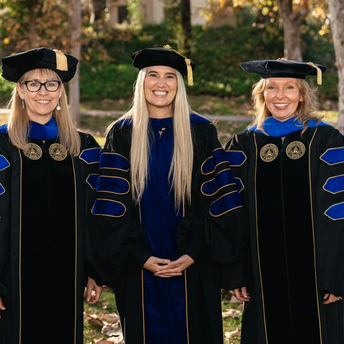 Three woman PhD graduates