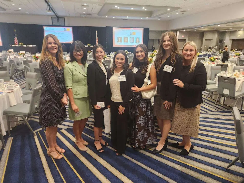 Women in Business club members and faculty advisors at event